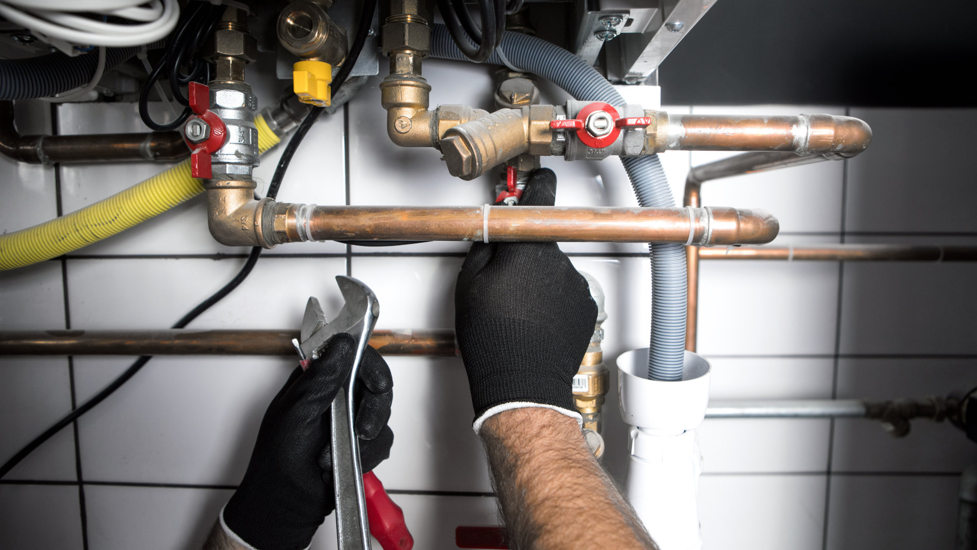 plumber working at home, work at the heating installation